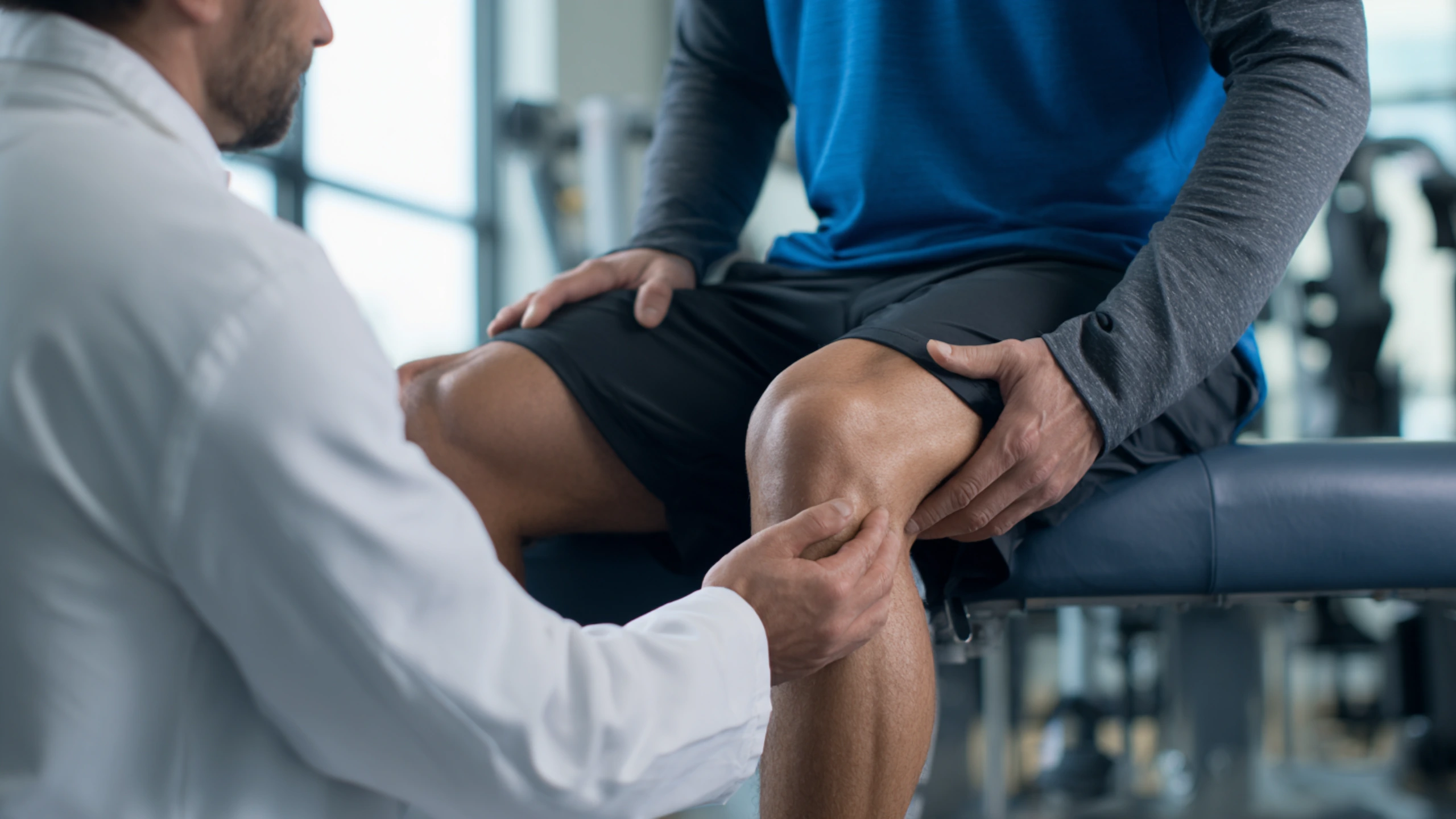 Orthopedic doctor examining a patient's knee injury at Instant Orthopedic Care in Draper, Utah.